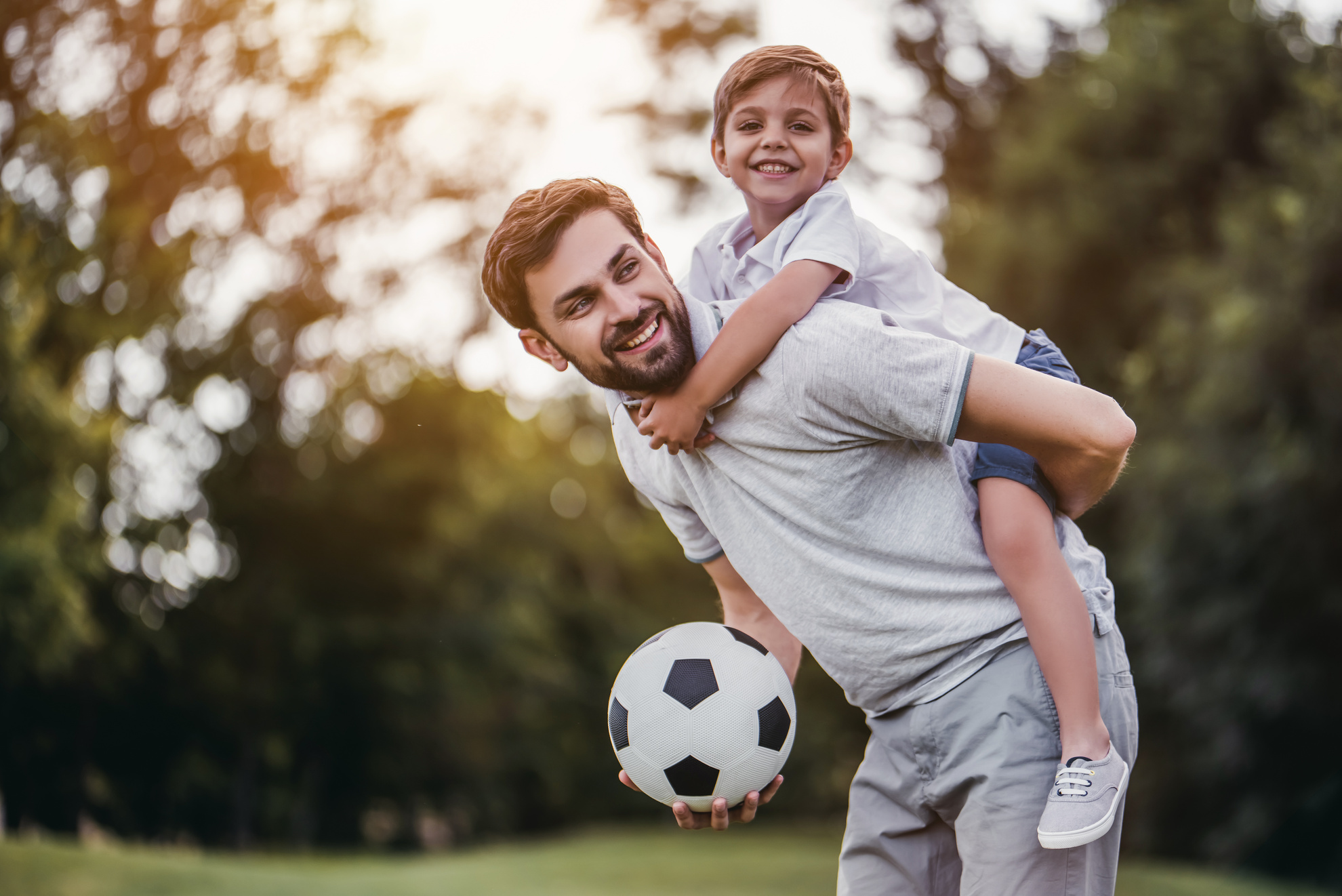 Dad with son playing football, soccer